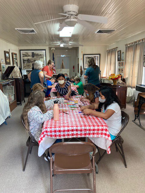 This is a photo of children doing a project in the Schoolhouse. 