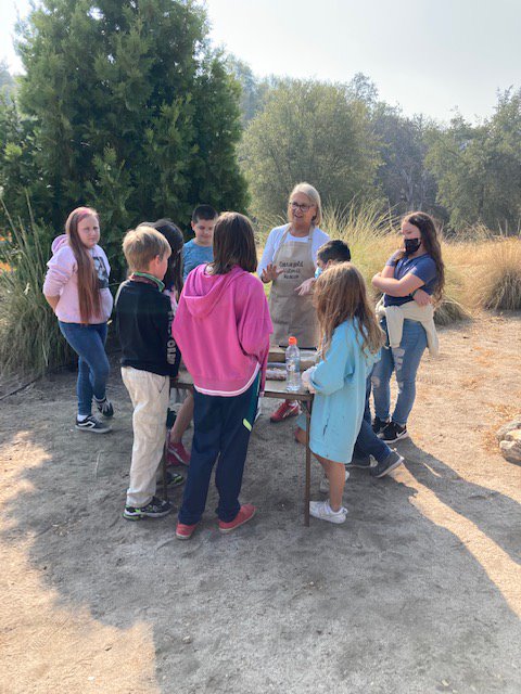 This is a photo of Karen Morris speaking with the children about the Native American history of the area.