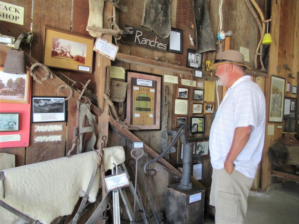 Photo of a man looking at a display inside the barn.