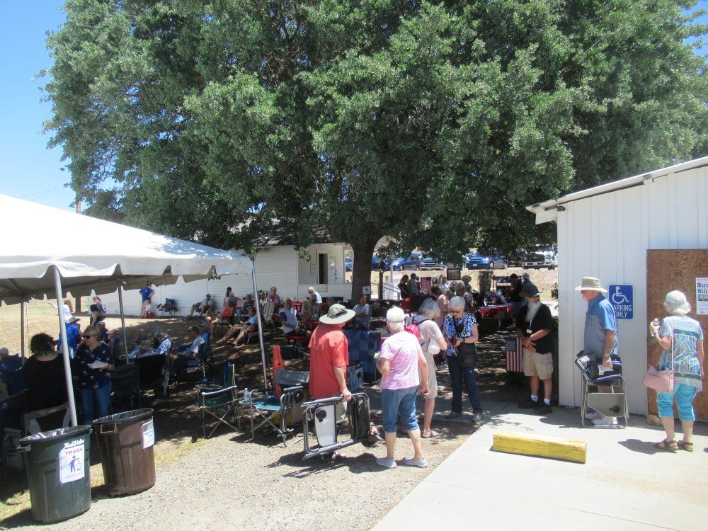 A photo of people gathering for the Music in the Meadow event.